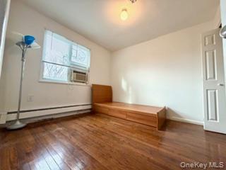216-11 73rd Avenue, Unit DUPLEX Queens, NY 11364 - Photo 3 of 27 bedroom featuring dark wood-style flooring, baseboard heating, and cooling unit
