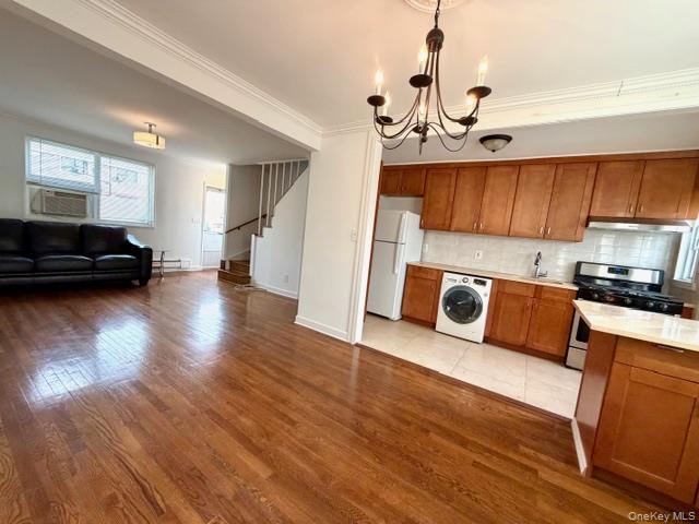 216-11 73rd Avenue, Unit DUPLEX Queens, NY 11364 - Photo 26 of 27 a kitchen with a refrigerator and a stove top oven