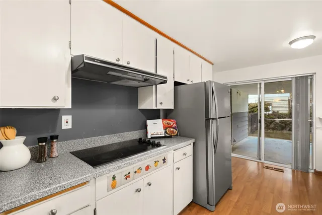 a kitchen with stainless steel appliances granite countertop a refrigerator and a sink