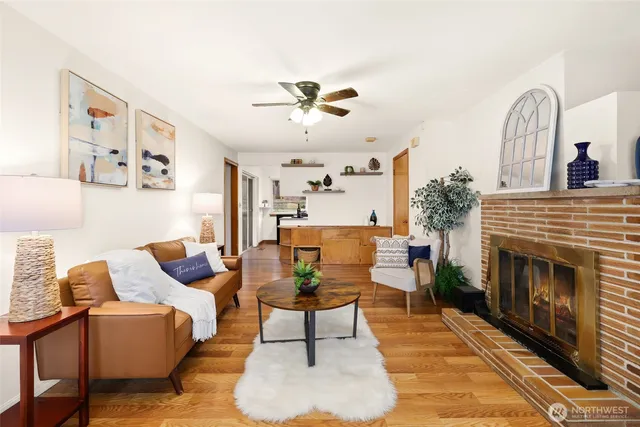 a living room with furniture a fireplace and a chandelier