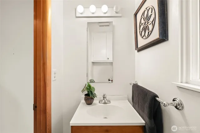 a bathroom with a sink a mirror and a window