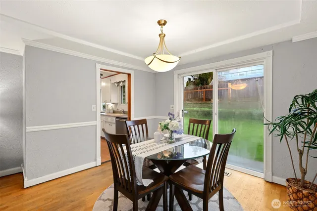 a view of a dining room with furniture window and wooden floor