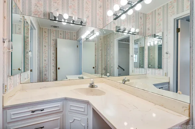 a bathroom with a sink and a mirror