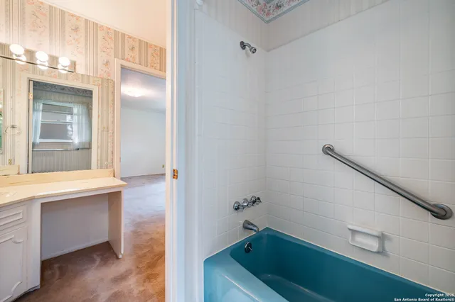 a bathroom with a sink a toilet and tub