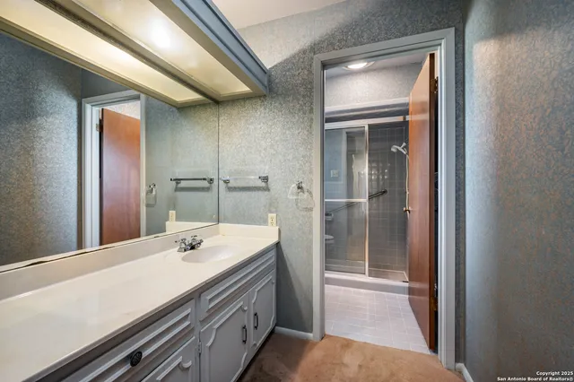 a bathroom with a double vanity sink and mirror