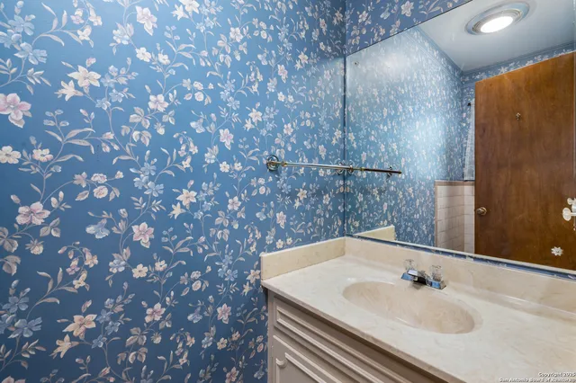 a bathroom with a sink and vanity
