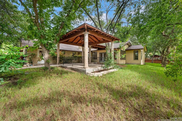 a front view of a house with a yard table and chairs