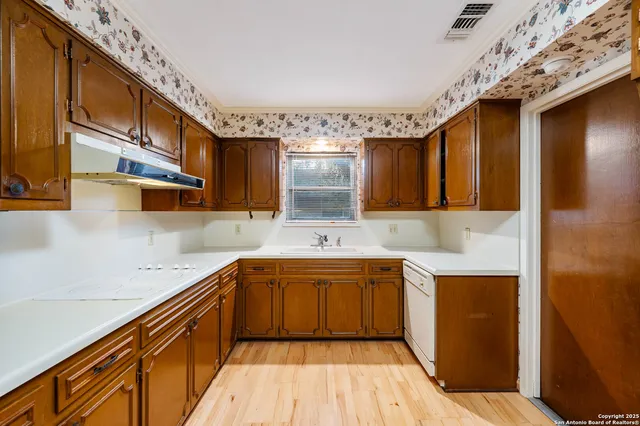 a kitchen with a sink and cabinets