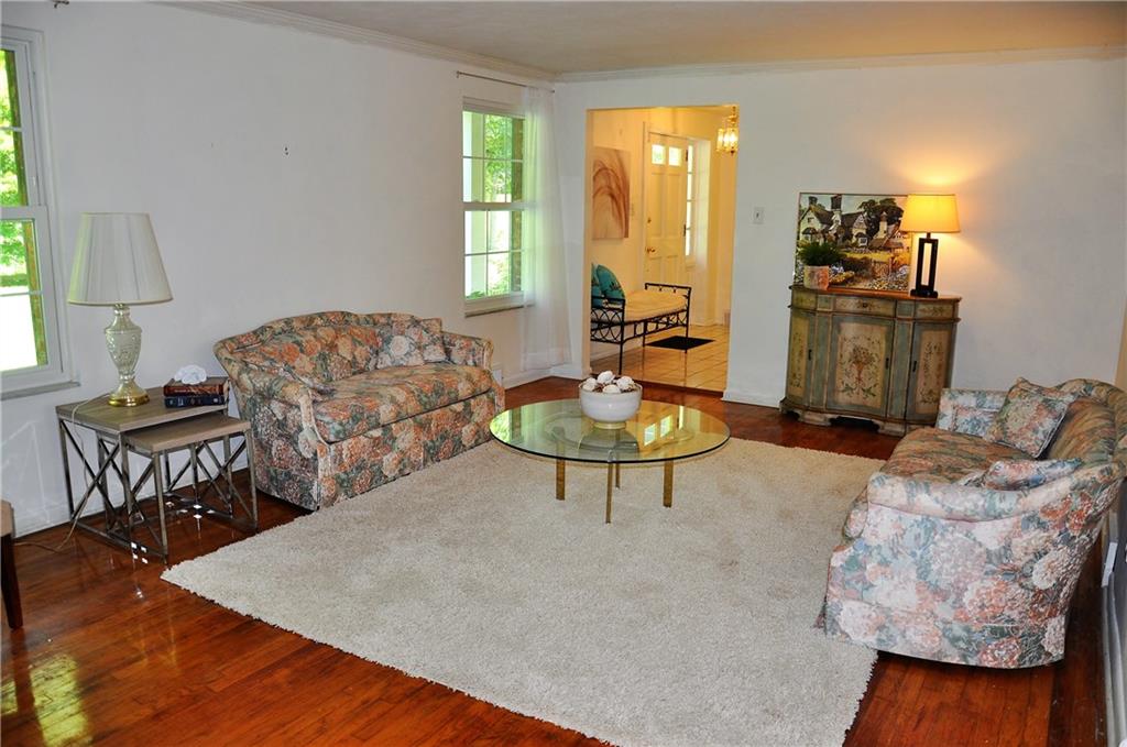 999 Old Mill Road Cheswick, PA 15024 - Photo 12 of 24 Living room with hardwood flooring, directly off entrance way and adjacent to the dining room. Measures 22x12.