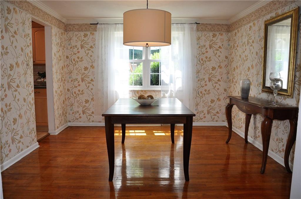 999 Old Mill Road Cheswick, PA 15024 - Photo 13 of 24 Dining room with hardwood flooring, adjacent to the living room and kitchen. Measures 12x11.