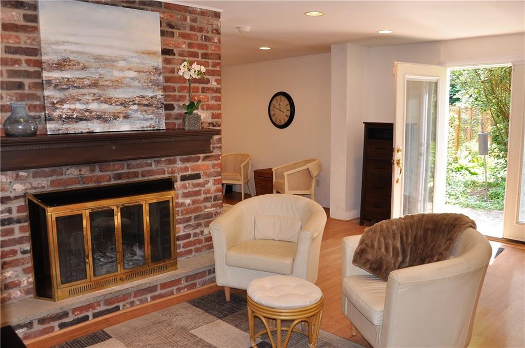 999 Old Mill Road Cheswick, PA 15024 - Photo 3 of 24 Wood Burning fireplace and french doors lead from kitchen area to back yard pool and gazebo.