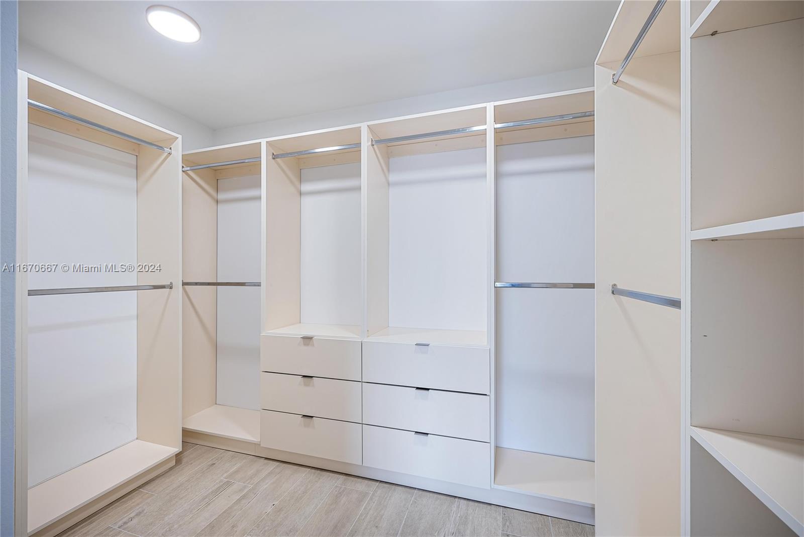 8855 Collins Avenue, Unit 5G Surfside, FL 33154 - Photo 12 of 41 a view of an empty walk in closet