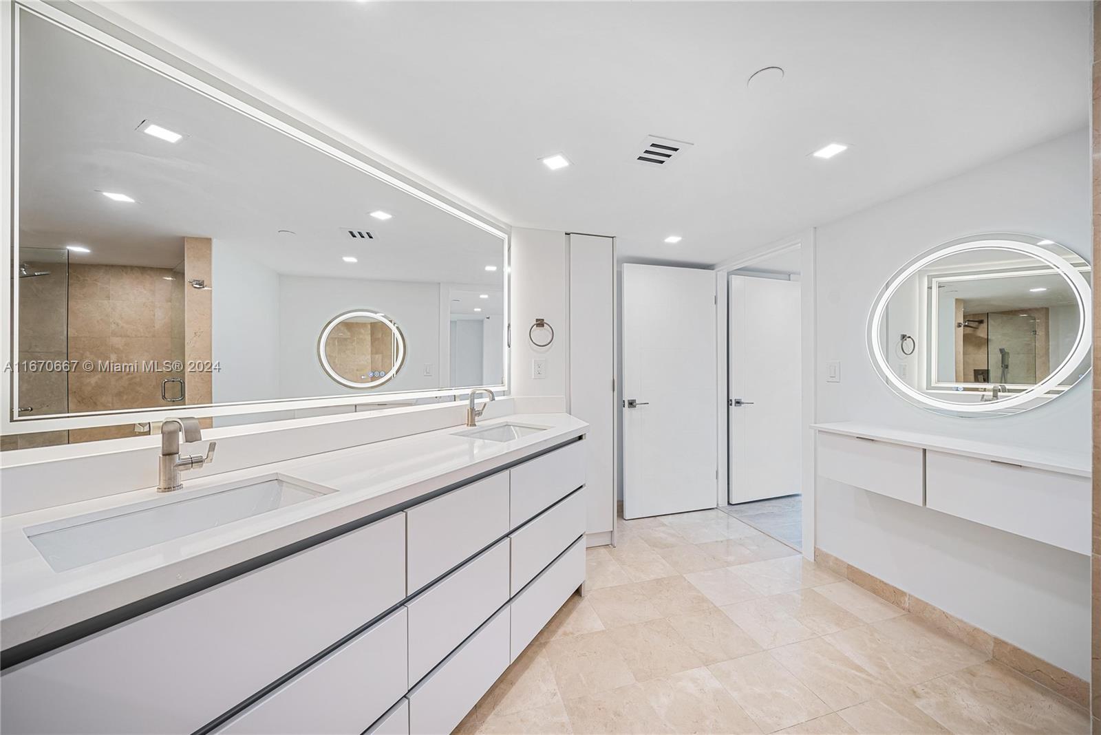 8855 Collins Avenue, Unit 5G Surfside, FL 33154 - Photo 13 of 41 a bathroom with a double vanity sink mirror and bathtub