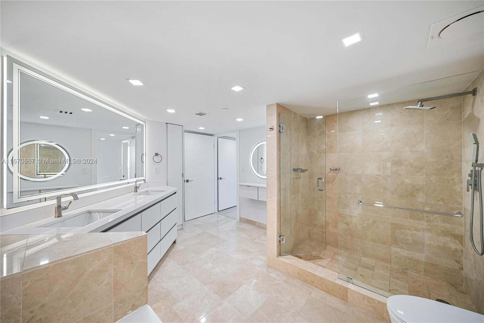 8855 Collins Avenue, Unit 5G Surfside, FL 33154 - Photo 14 of 41 a bathroom with a double vanity sink a mirror and shower