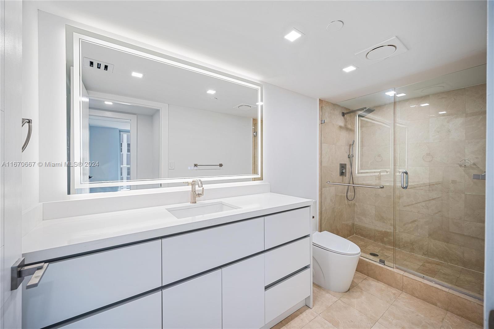 8855 Collins Avenue, Unit 5G Surfside, FL 33154 - Photo 20 of 41 a bathroom with a sink a toilet and shower