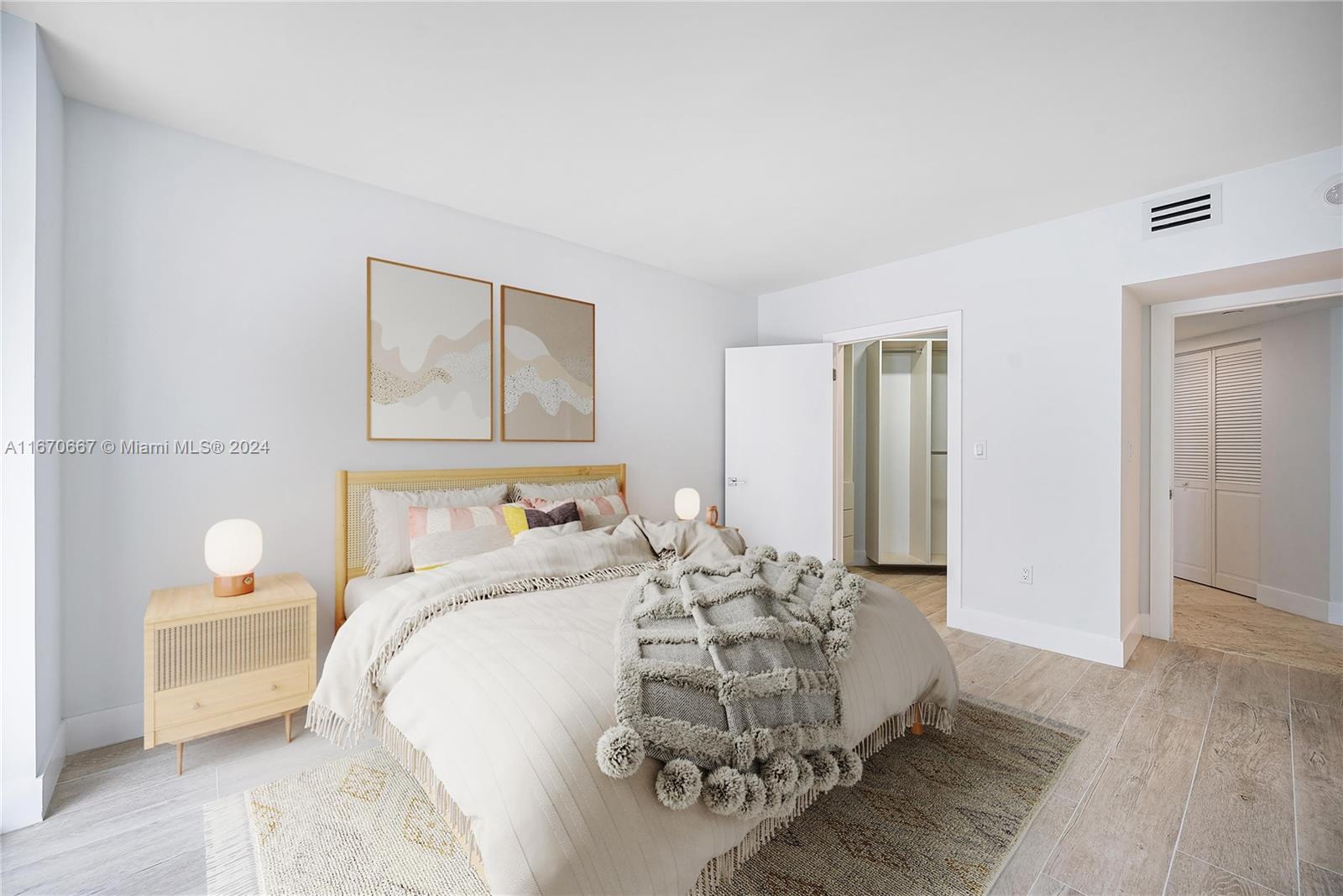 8855 Collins Avenue, Unit 5G Surfside, FL 33154 - Photo 22 of 41 a bedroom with a bed and a chandelier