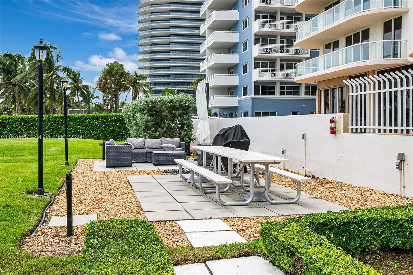 8855 Collins Avenue, Unit 5G Surfside, FL 33154 - Photo 34 of 41 a view of a patio with couches table and chairs and potted plants