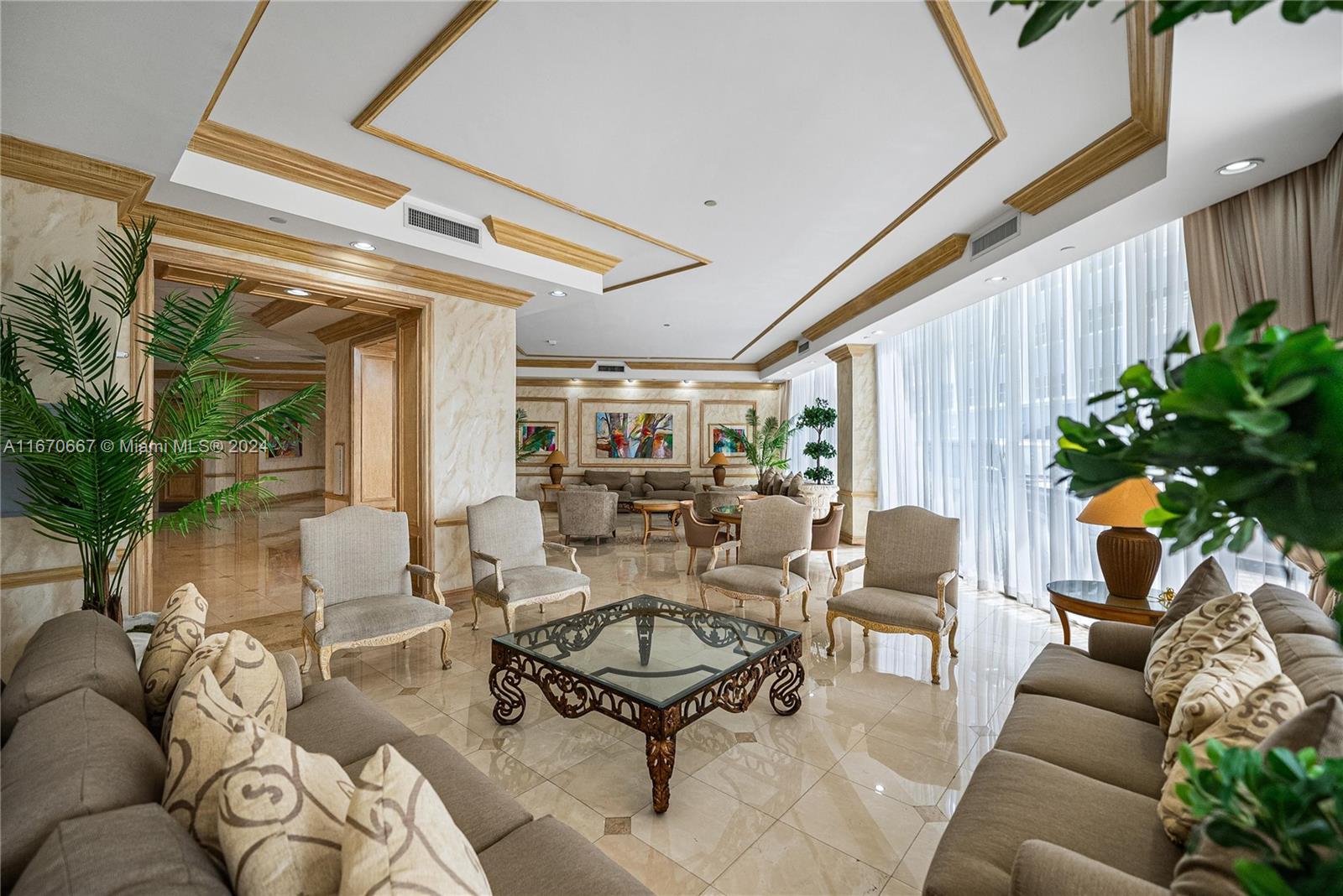 8855 Collins Avenue, Unit 5G Surfside, FL 33154 - Photo 39 of 41 a living room with furniture and a chandelier