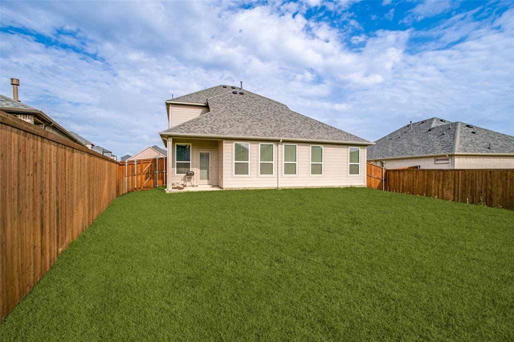3115 Giovanni Point Princeton, TX 75407 - Photo 23 of 26 Expansive backyard featuring a manicured lawn, full privacy fencing, and a concrete patio