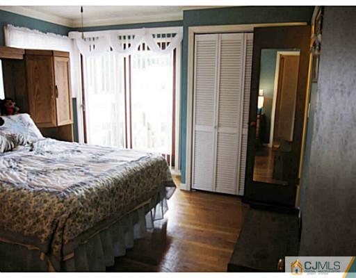 19 Wellesley Road Old Bridge, NJ 08859 - Photo 15 of 25 a bedroom with a bed and wooden floor