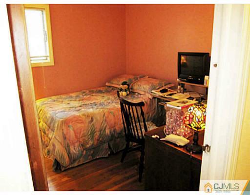 19 Wellesley Road Old Bridge, NJ 08859 - Photo 18 of 25 a bed sitting in a bedroom next to a window