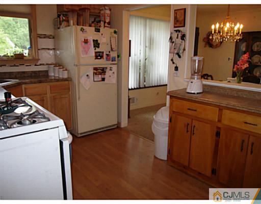 19 Wellesley Road Old Bridge, NJ 08859 - Photo 9 of 25 a kitchen with stainless steel appliances a refrigerator and a stove