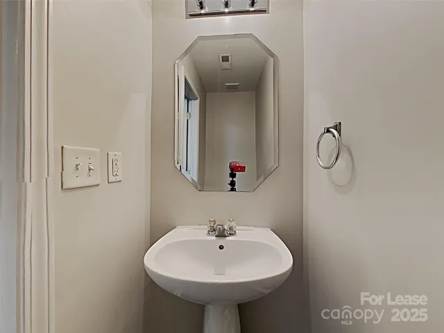 a bathroom with a sink a mirror and shower