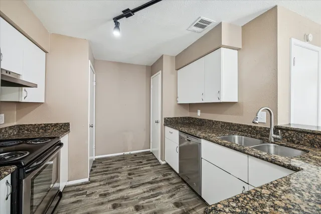 a kitchen that has a sink and a stove