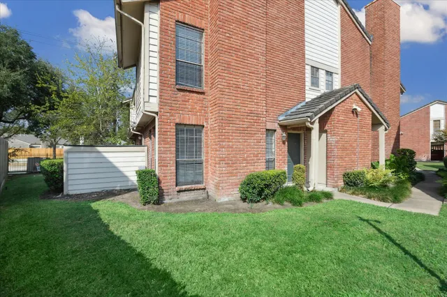 a front view of a house with a garden and plants