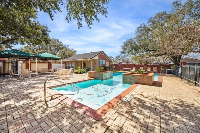 a view of house with swimming pool outdoor seating