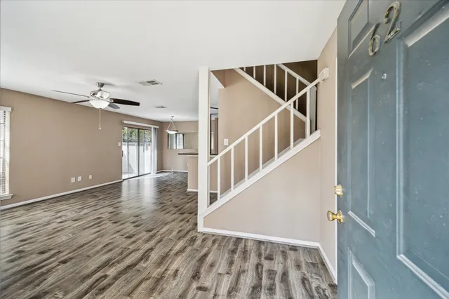a view of entryway and hall with wooden floor