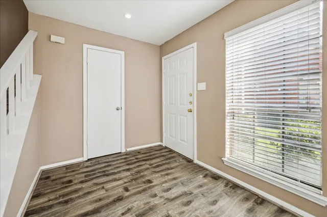 a view of a livingroom with wooden floor and a window