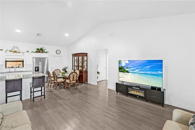 a dining room with furniture and wooden floor