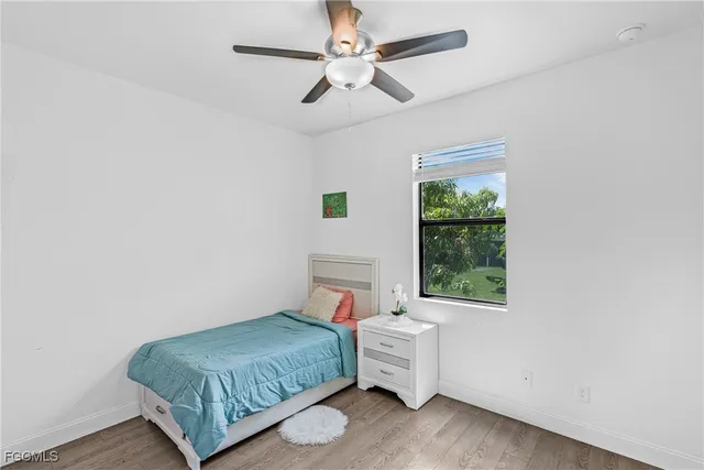 a view of room with window ceiling fan and hardwood floor