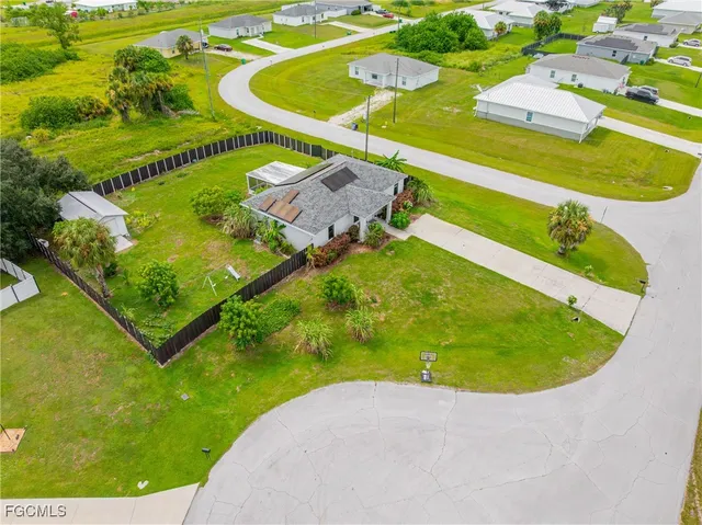 an aerial view of a swimming pool with a swimming pool and outdoor seating