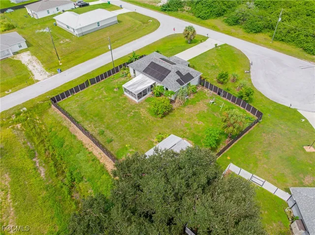 an aerial view of residential houses with outdoor space and swimming pool