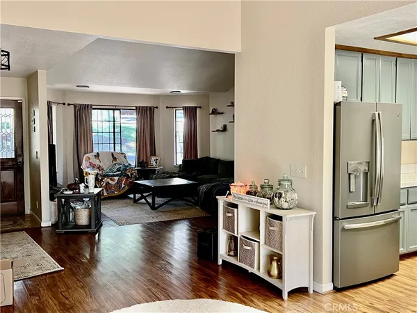 a very nice looking living room with dining room and wooden floor