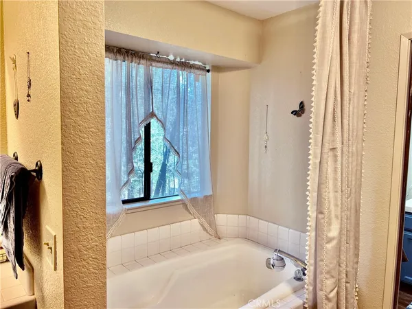 a bathroom with a tub and shower