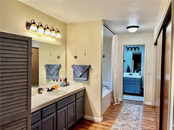 a bathroom with a sink mirror and a bathtub