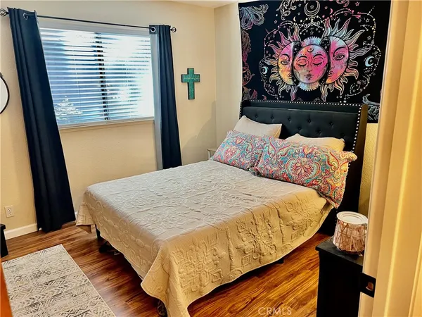 a bed sitting in a bedroom next to a window