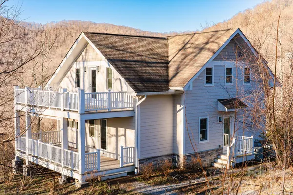 a view of a house with wooden fence
