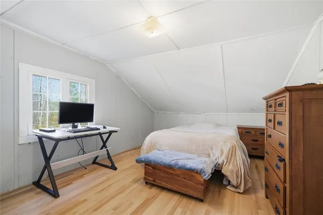 a bedroom with a bed and a desk