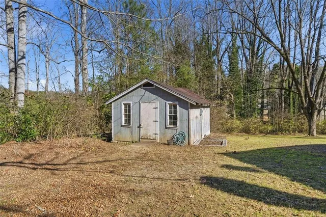a view of a house with a yard covered in snow