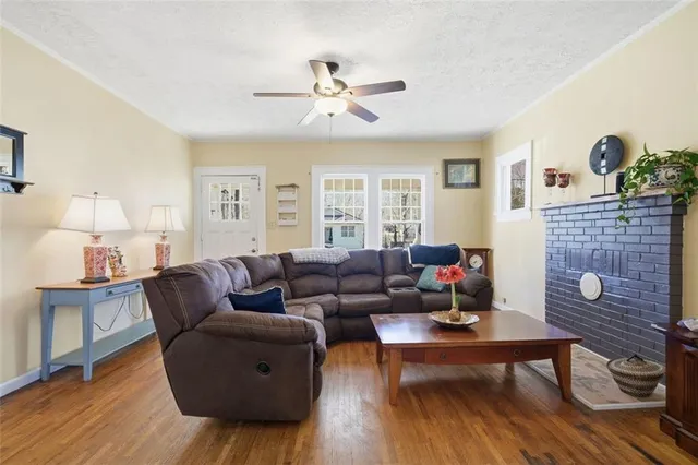 a living room with furniture and wooden floor