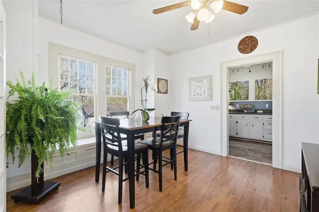 a view of a dining room with furniture and wooden floor