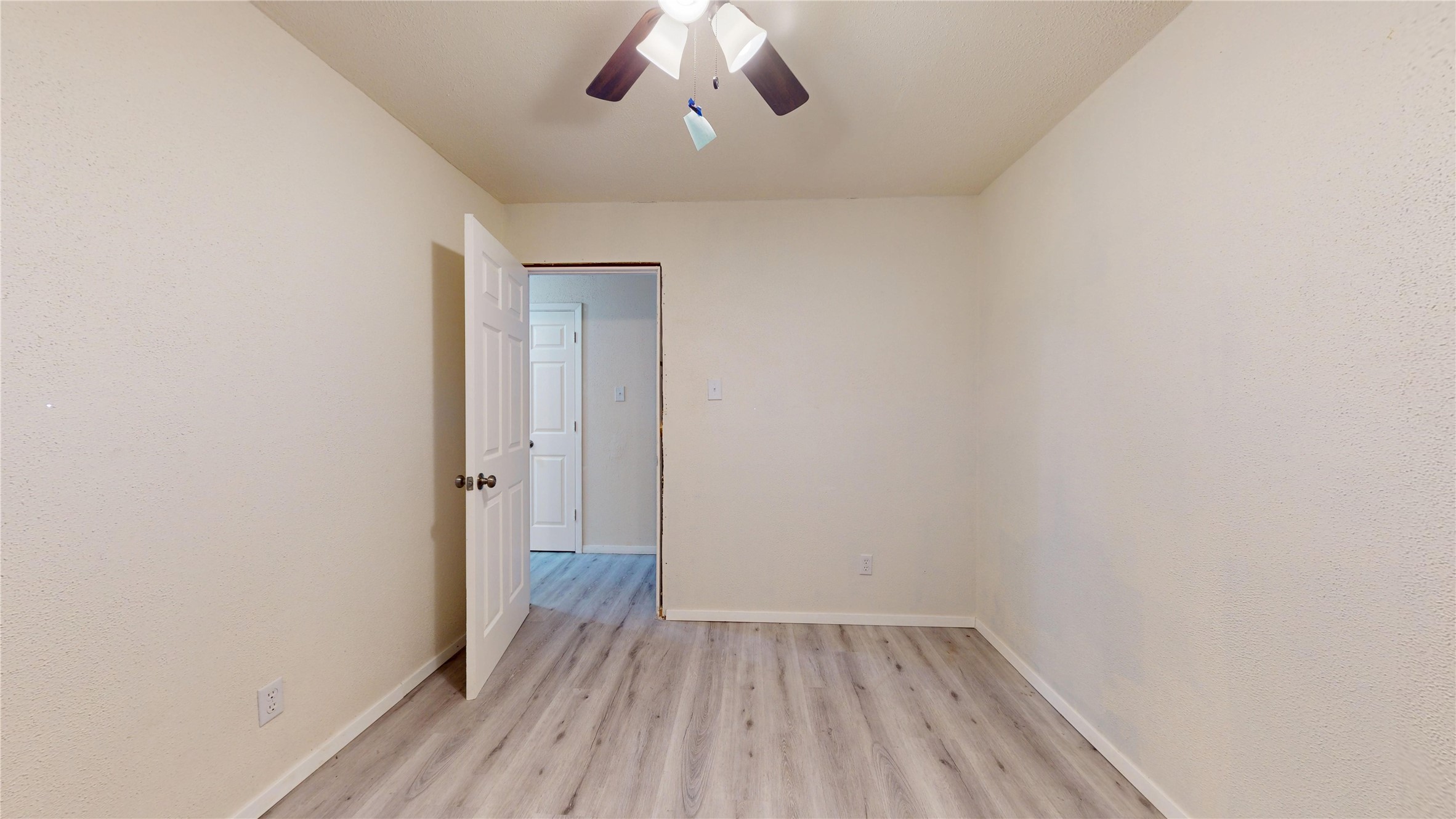 7115 Inkberry Drive Houston, TX 77092 - Photo 15 of 31 a view of a room with wooden floor and a ceiling fan