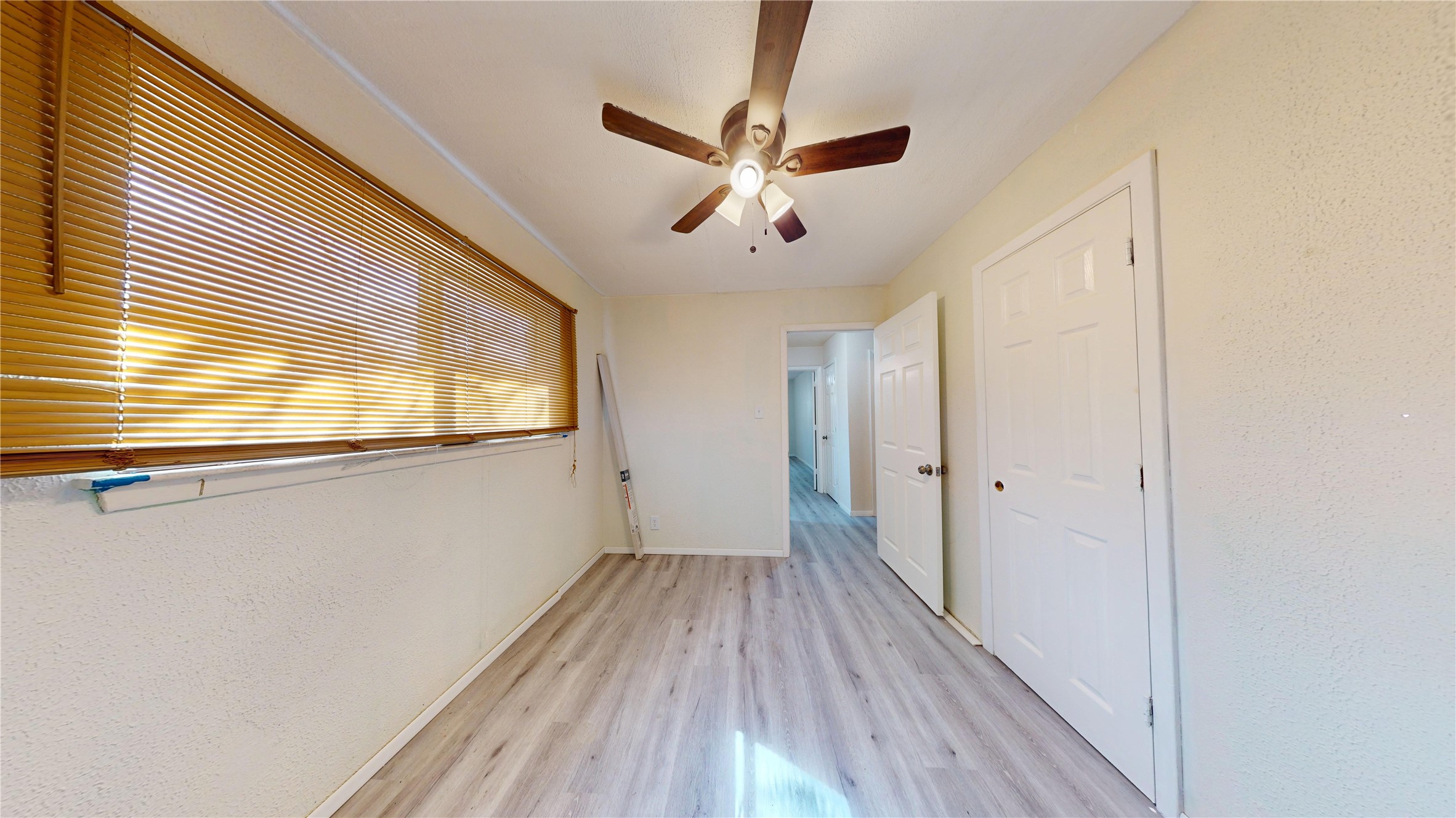 7115 Inkberry Drive Houston, TX 77092 - Photo 19 of 31 a view of empty room with wooden floor and fan