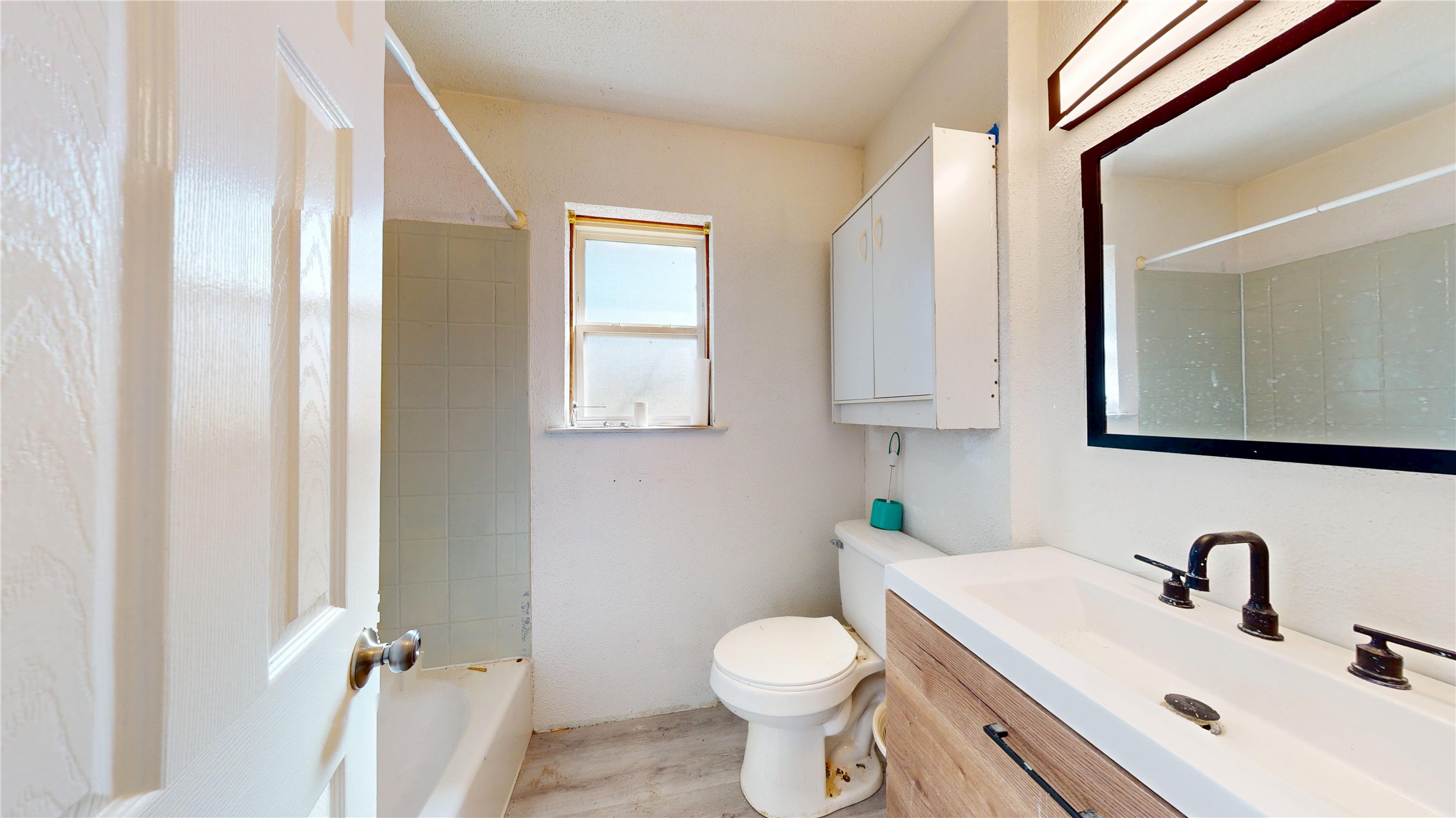 7115 Inkberry Drive Houston, TX 77092 - Photo 22 of 31 a bathroom with a sink toilet and mirror