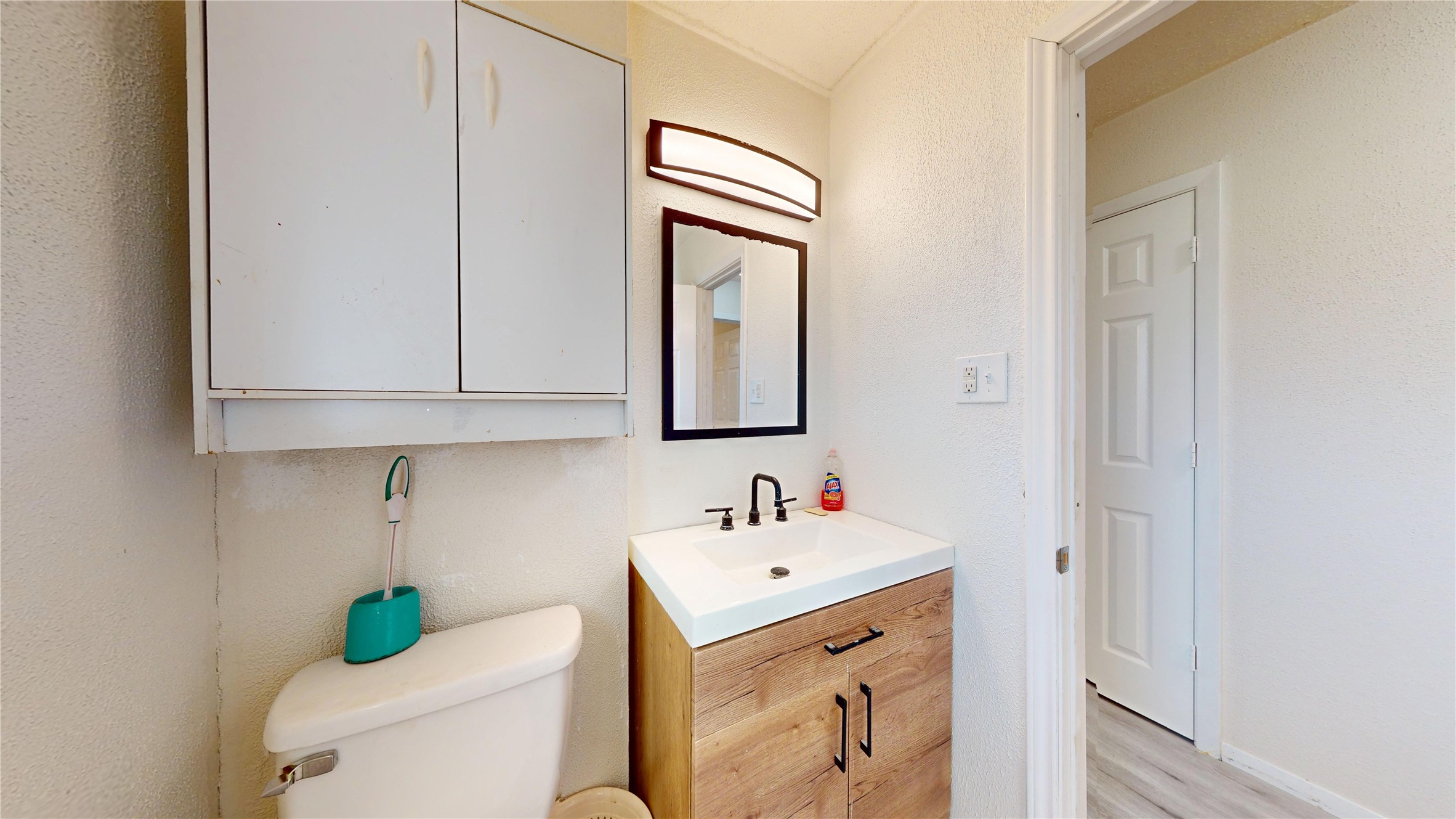 7115 Inkberry Drive Houston, TX 77092 - Photo 24 of 31 a bathroom with a toilet sink and mirror
