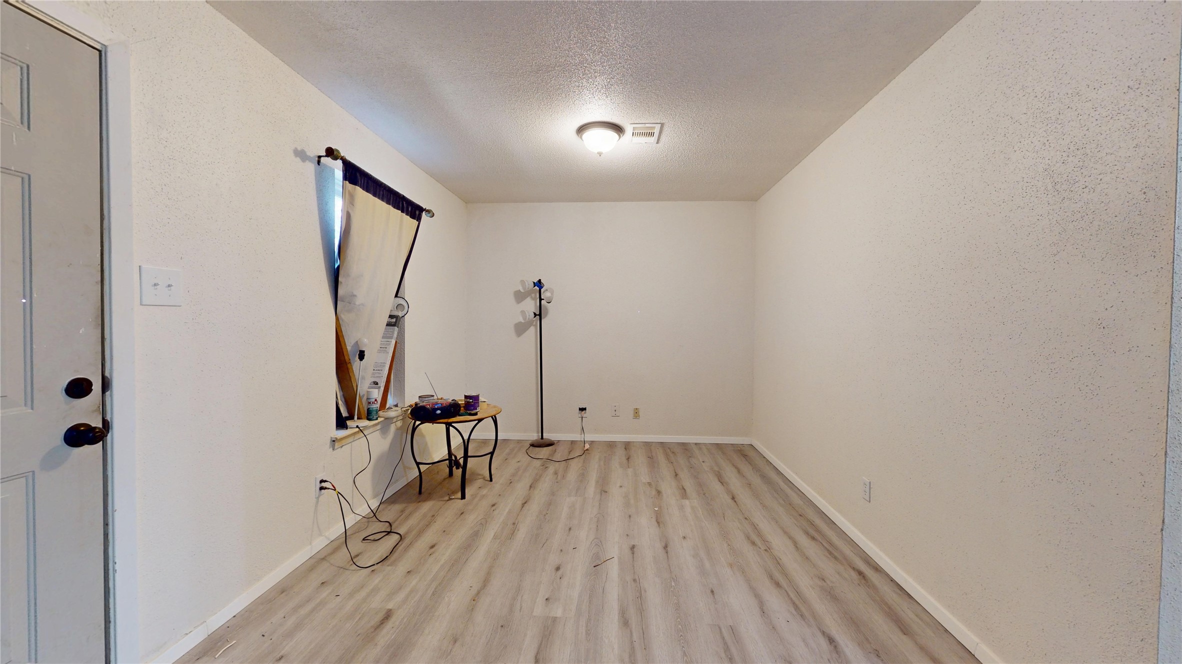 7115 Inkberry Drive Houston, TX 77092 - Photo 6 of 31 a view of a room with wooden floor and a ceiling fan